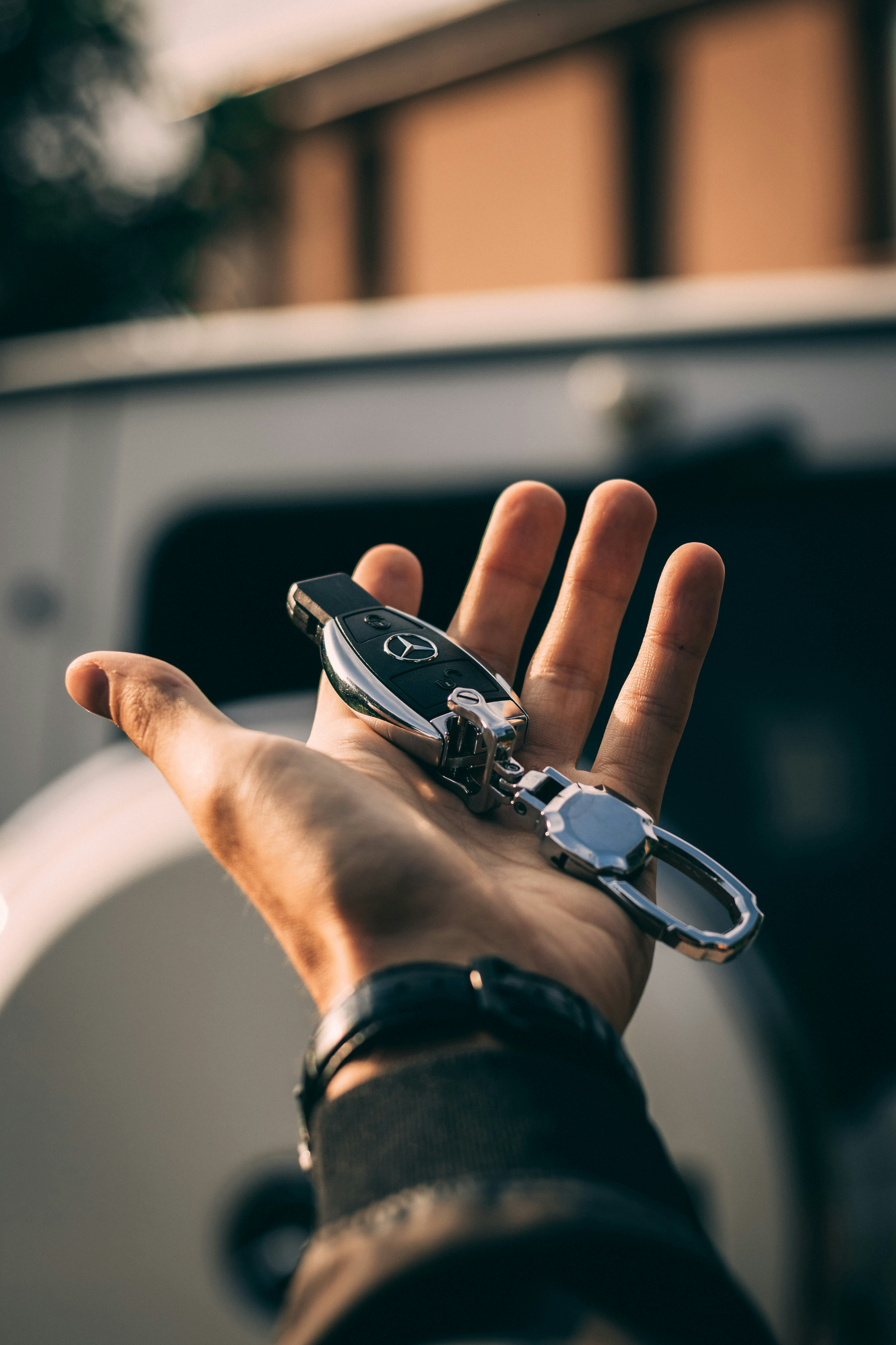 Person holding Mercedes-Benz fob by Roland Denes